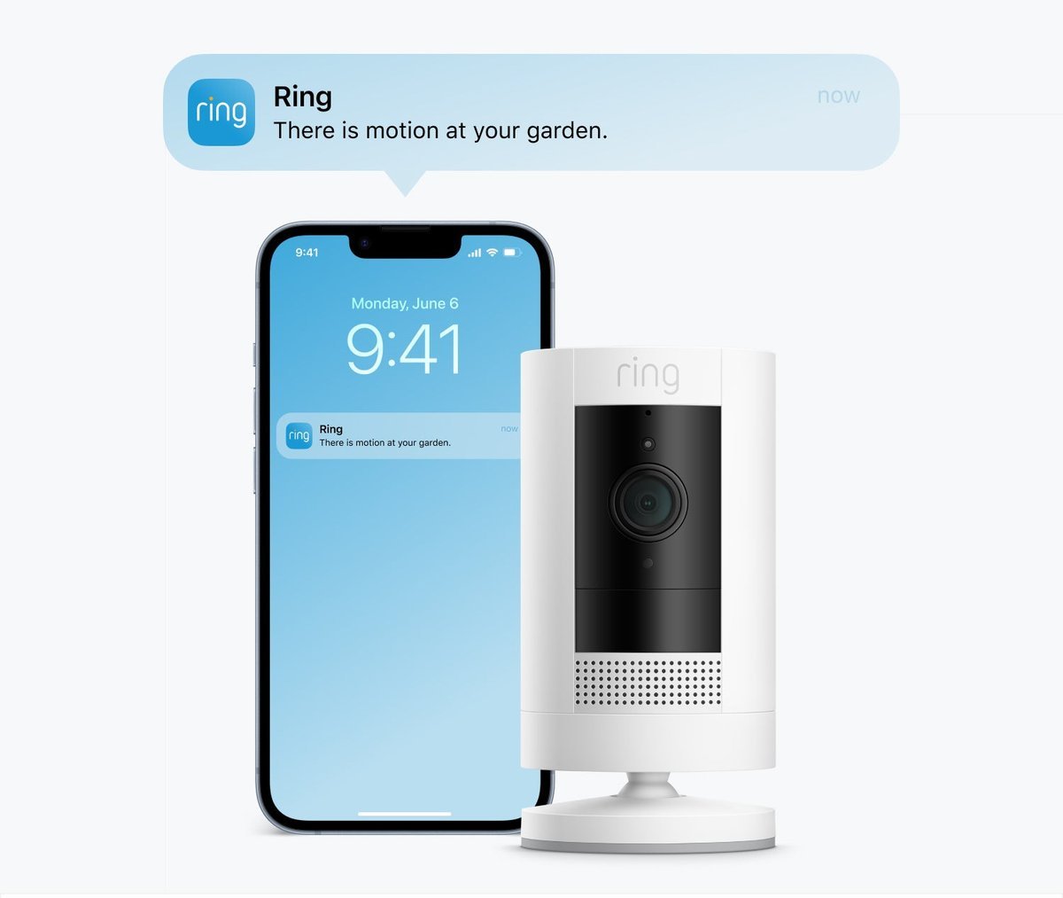 Ring Outdoor Cam (Stick Up Cam) Battery in white standing beside a phone with a motion notification