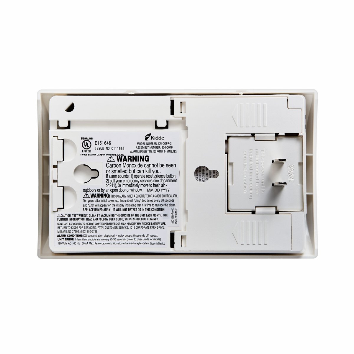 Kidde Nighthawk KN-COPP-3, rear view showing the AC plug prongs, battery compartment and warning label, product photo 3 of 3